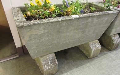 A weathered rectangular stoneware planter with blocks and flowersCondition Report...