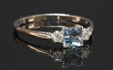 A white gold three stone aquamarine and diamond ring