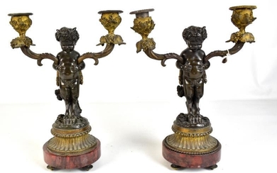 AFTER CLODION; a pair of bronze figural two branch...