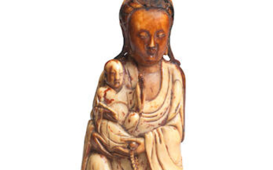AN IVORY FIGURE OF GUANYIN AND CHILD