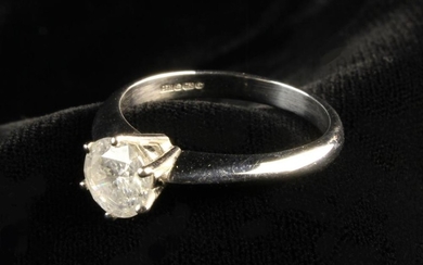 An 18 Carat White Gold Solitaire Diamond Ring. The round brilliant cut stone measuring 6.6 mm in