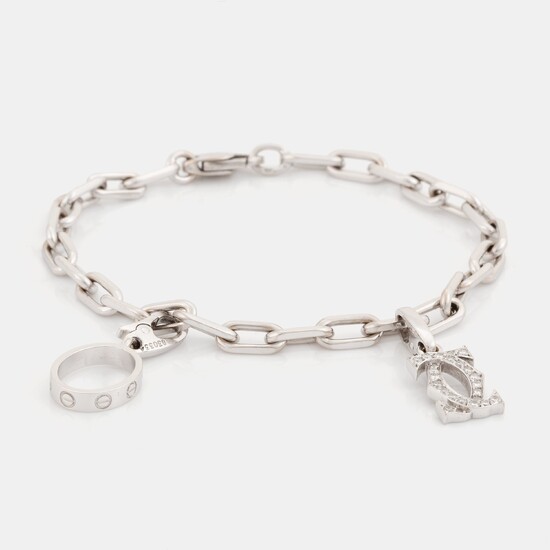 An 18K white gold Cartier "Spartacus" bracelet with two charms