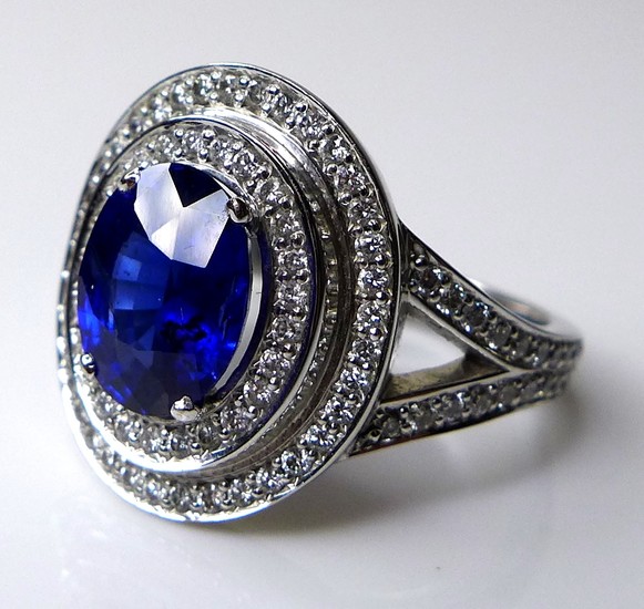 An 18ct white gold, sapphire and diamond dress ring, the dar...