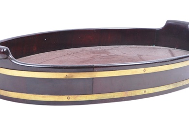 An 18th Century George III mahogany and brass bound serving tray. The tray of oval form with gallery edge and raised shaped twin carry handles. Pinned brass mounts to sides. Measures approx. 58cm x 37cm.