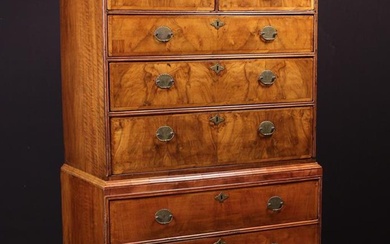 An 18th Century Walnut Veneered Tallboy. The upper section having a moulded top above a shallow bulg
