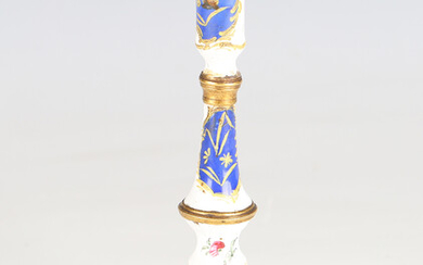 An 18th century South Staffordshire enamel candlestick, decorated with blue panels and flowers again