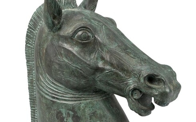An Italian bronze horse's head, after the Horses of Saint Mark, Venice, early 20th century, on an associated oval marble base, 31cm high Provenance: The Geoffrey and Fay Elliot collection.