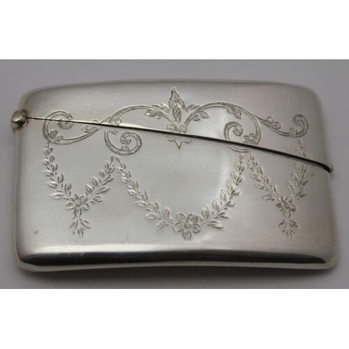 An early 20th century silver card case of curved pocket form...
