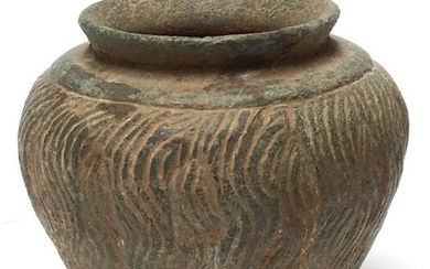 Ball vase in grey shale with carved waves...