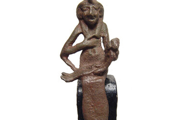 Egyptian bronze figure of Isis suckling infant Horus