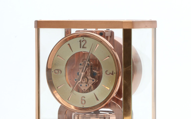 JAEGER LE COULTRE. Table clock. “Atmos”. Copper-colored metal and glass. Second half of the 20th century. With original case and brochure.