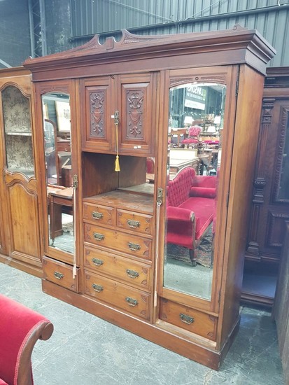 Late Victorian Walnut Wardrobe, with two carved panel doors, open shelf and five drawers, flanked by long mirror doors