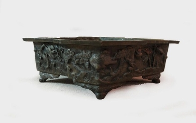 Lozenge-shaped planter in patinated bronze decorated with turtles and birds.