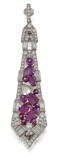 Mauboussin, An Art Deco, platinum, ruby and diamond pendant by Mauboussin, the elongated kite-shaped panel set in the centre with a cluster of claw-set carved rubies, (one ruby deficient) with pinned ruby bead detail, within brilliant and...