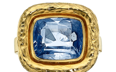 Sapphire, Gold Ring The ring centers a cushion-shaped sapphire...