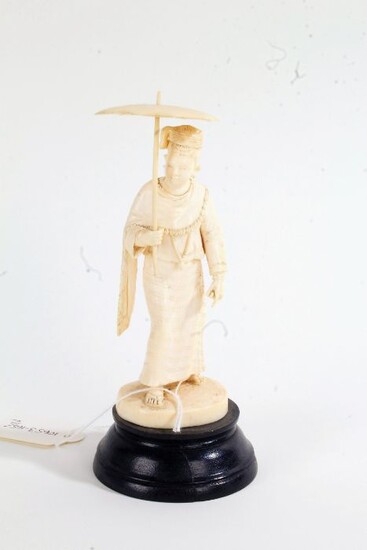 Two Japanese ivory Okimonos, early 20th Century, as a lady holding an umbrella and the other with