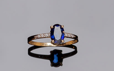 Yellow gold ring with oval diffusion sapphire center, in...