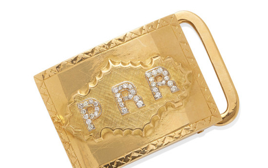 a gold and diamond monogram belt buckle