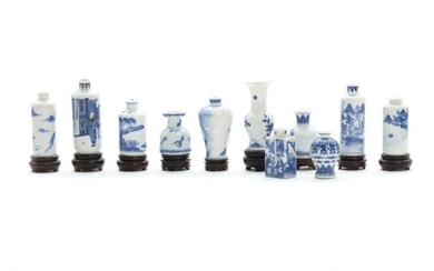 A selection of Chinese miniature porcelain vases in different shapes. Nine wooden bases enclosed. 19th century. H. 5–8.5 cm. (20)