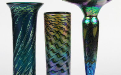 Lundberg Studios art glass group, consisting of a floral form iridescent example, having an iridescent oil spot exterior...