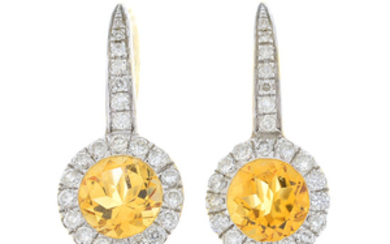 A pair of citrine and diamond cluster earrings.