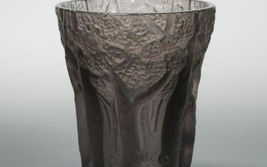 An early 20th century moulded amethyst glass vase