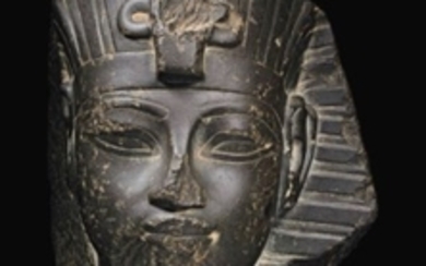 AN EGYPTIAN GREYWACKE PORTRAIT HEAD OF AMENHOTEP III, NEW KINGDOM, 18TH DYNASTY, REIGN OF AMENHOTEP III, 1390-1352 B.C.