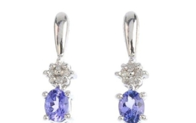 A pair of tanzanite and diamond earrings. Each designed