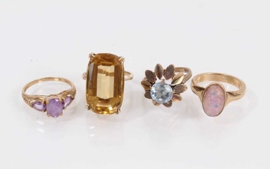 9ct gold large citrine cocktail ring, two other 9ct gold gem set dress rings and a yellow metal opalescent cabochon ring (4)