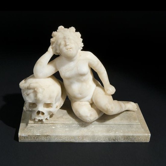 A 18th century alabaster group of Cupid on a skull