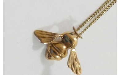 A 9 carat gold bee pendant, London 1983, 2.2cm wide, on chai...
