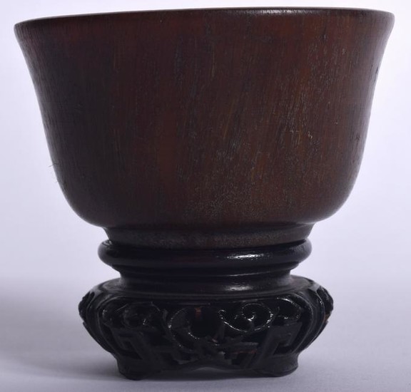 A CHINESE HORN BOWL ON HARDWOOD STAND, formed with a