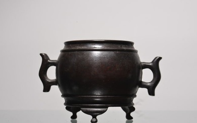 A Chinese Carved Bronze Tripod Incense Burner with Double Ears