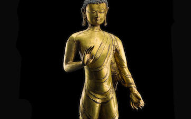 A GILT COPPER ALLOY FIGURE OF STANDING BUDDHA
