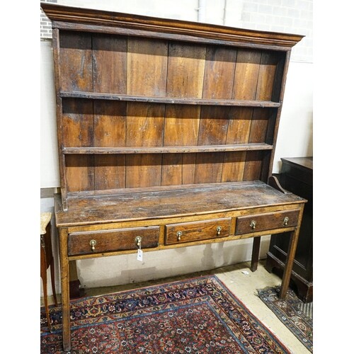 A George III oak dresser, with two shelf rack and three long...