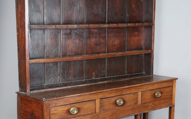A George III provincial mahogany dresser, the plate rack above three drawers and chamfered supports