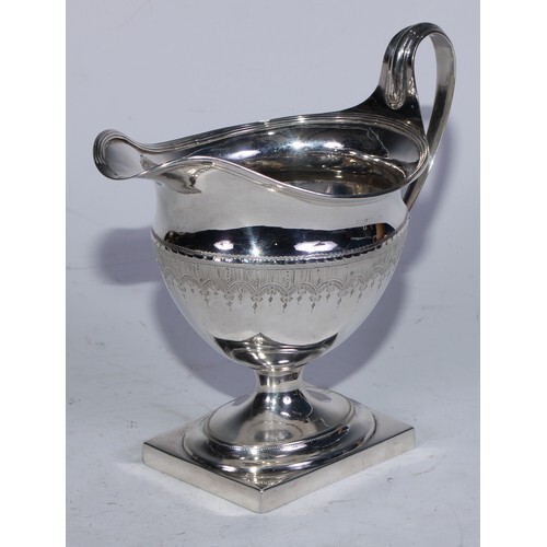 A George III silver boat shaped pedestal cream jug, bright-c...