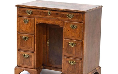 A George III walnut, feather banded and crossbanded kneehole desk...