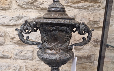 A PAIR OF BRONZE TWO HANDLED URN FORM TABLE LAMPS SUPPORTED ON SQUARE SERPENTINITE PLINTHS. H