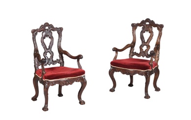 A PAIR OF IBERIAN CARVED WALNUT OPEN ARMCHAIRS IN 18TH CENTURY STYLE
