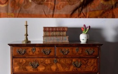 A Queen Anne walnut and feather banded chest of drawers, circa 1710