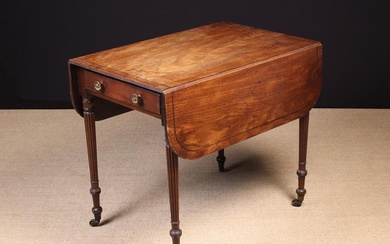 A Regency/George IV Mahogany Pembroke Table. The top with rounded drop leaves on fly bracket support