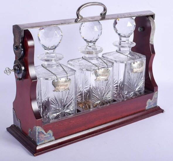 A SILVER PLATED AND SILVER DECANTER SET within a