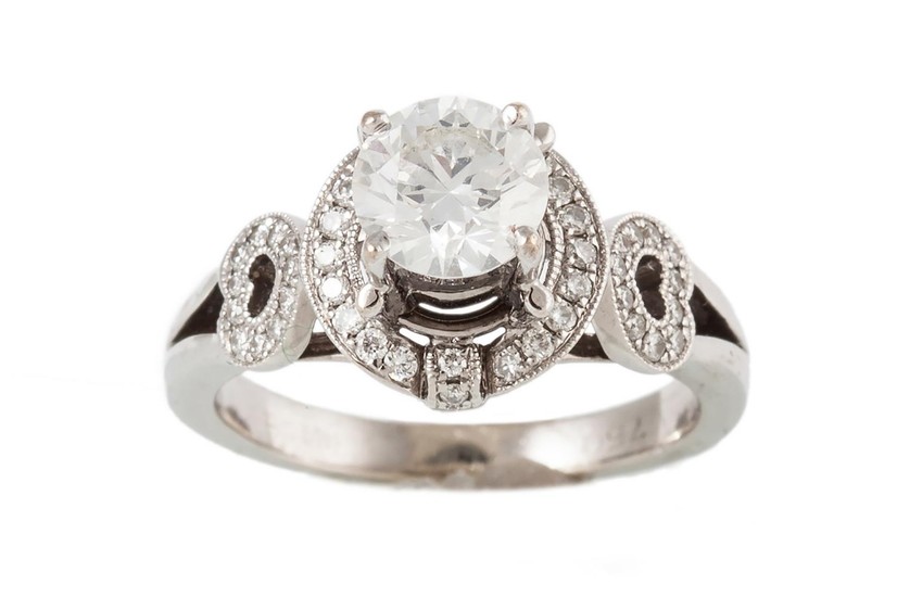 A SOLITAIRE DIAMOND RING, the brilliant cut diamond to a dia...