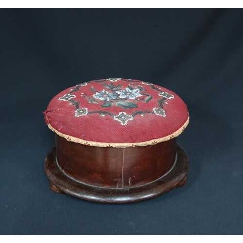 A Victorian circular needlepoint upholstered footstool on bu...