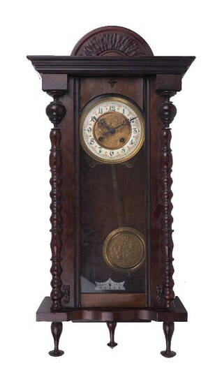 A Vienna style rectangular eight-day wall clock, late 19th century, with enamel chapter ring with Roman numerals, the case with turned twin pilasters flanking glazed door, pendulum with brass bob and key, 73cm high Please note that Roseberys do not...