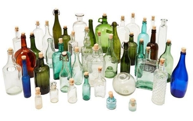 A collection of glass bottles and jars,...