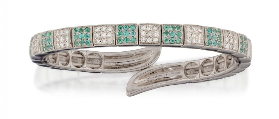 A diamond and tourmaline bangle by Gavello, of sprung open half-hoop design, the front composed of a series of alternate brilliant-cut diamond or circular greenish blue tourmaline nine stone square clusters, signed Gavello, internal width 5.4cm