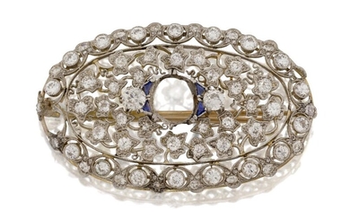 A diamond brooch, with central stone deficient, in the form of an oval pierced foliate panel set with old-brilliant-cut diamonds, one deficient, set with four calibre sapphires, approx. length 48cm(VAT charged on hammer price)