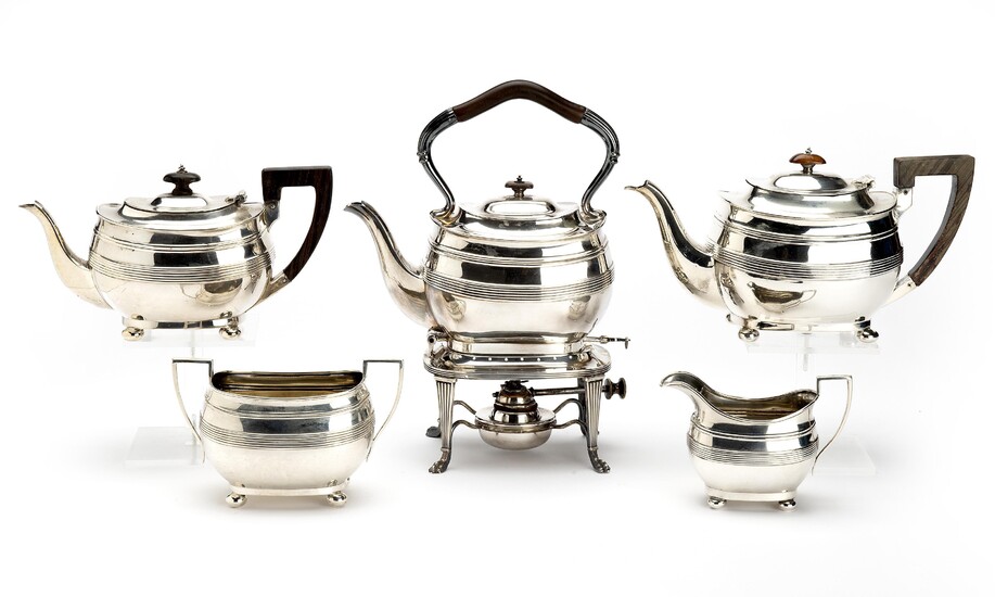 A five-piece tea service with burner and stand